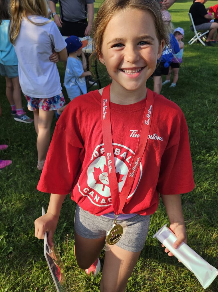 U7 Norah - smiling with medal